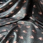 Au mètre Jersey lycra polyester kaki hirondelles dorées en 150cm  n°10280