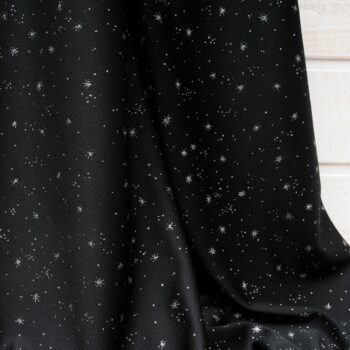 Au mètre maille polyester noire motif étoile argentée scintillant en 155cm n°10475