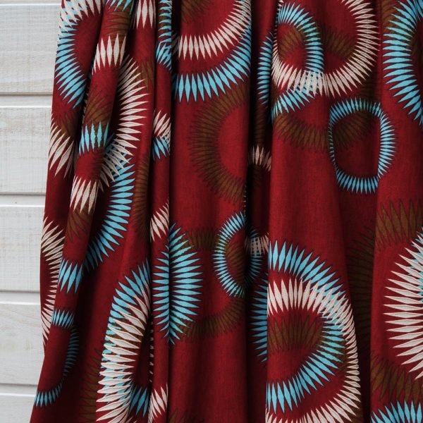 Coupon Jersey Viscose fond bordeaux rouille à cercles turquoise et beiges 1m50