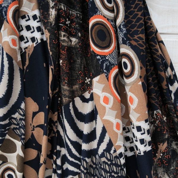 Jersey Viscose fond noir, cercles en orange et marron beige