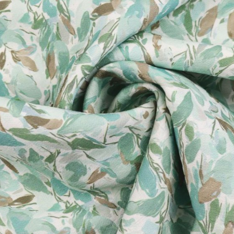 Crêpe Viscose motif petites feuilles fond vert amande