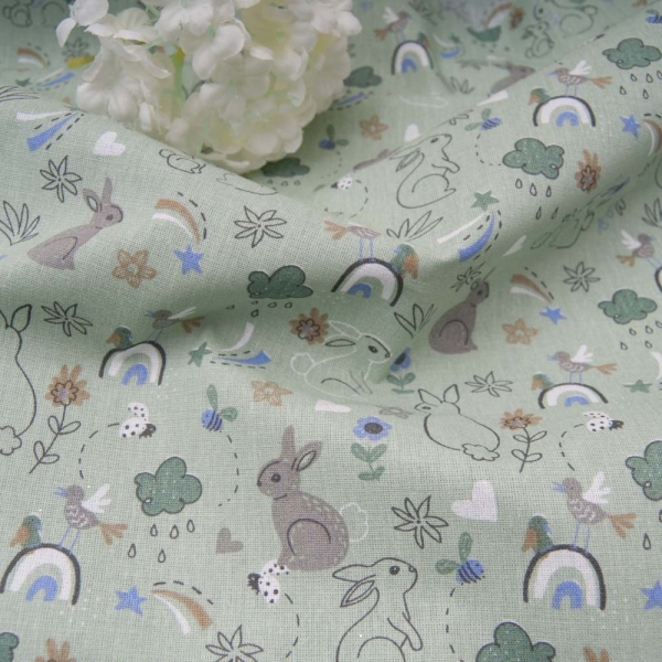 Tissu Coton fond vert amande imprimé petit lapin