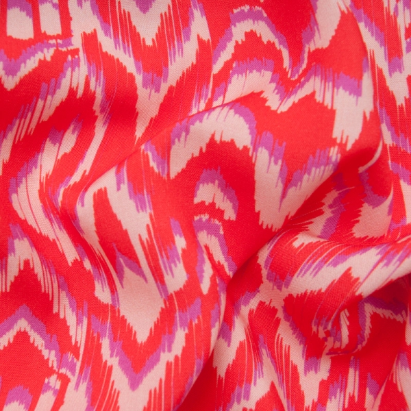 Viscose motif type Ikat sur fond vermillon motif mauve et beige